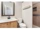 Bright bathroom featuring a stylish mirror, vanity with a sink, and tiled shower at 9705 Autumnwood Pl, Highlands Ranch, CO 80129