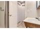 Well-lit bathroom featuring a wood vanity, sink, and tiled shower with a glass door at 9705 Autumnwood Pl, Highlands Ranch, CO 80129