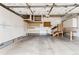 Spacious garage with white cabinetry and ample storage, and exposed ceiling at 9705 Autumnwood Pl, Highlands Ranch, CO 80129