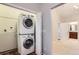 Bright laundry room with stacked washer and dryer at 9705 Autumnwood Pl, Highlands Ranch, CO 80129