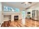 Bright living room with modern fireplace, high ceilings and sliding door to a garden at 9705 Autumnwood Pl, Highlands Ranch, CO 80129