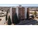 Aerial view of high-rise featuring private balconies and surrounding neighborhood with lush greenery at 4570 E Yale Ave # 507, Denver, CO 80222