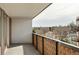 A view from a balcony overlooking a quiet street with mature trees and a patterned concrete railing at 4570 E Yale Ave # 507, Denver, CO 80222