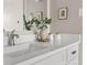 Close-up of a well-decorated bathroom sink and countertop area with flowers and marble-look countertop at 4570 E Yale Ave # 507, Denver, CO 80222
