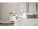 Neutral bedroom featuring a bed with white linens, modern nightstand, and elegant abstract art at 4570 E Yale Ave # 507, Denver, CO 80222