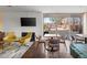 Inviting common area with comfortable seating, fireplace, TV, and view of the outdoor courtyard at 4570 E Yale Ave # 507, Denver, CO 80222