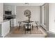 Dining area with round table, modern chairs, and adjacent kitchen space, creating an inviting open concept at 4570 E Yale Ave # 507, Denver, CO 80222