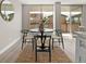 Dining area with a round table, four chairs, jute rug, and access to a patio through sliding glass doors at 4570 E Yale Ave # 507, Denver, CO 80222