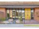 Apartment entrance with decorative gold doors, brick accents and a decorative rock garden at 4570 E Yale Ave # 507, Denver, CO 80222