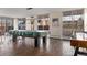 Spacious game room with a covered pool table, foosball table, and multiple windows at 4570 E Yale Ave # 507, Denver, CO 80222