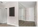 Well-lit hallway features mirrored closet doors, wood-look flooring, and neutral wall paint at 4570 E Yale Ave # 507, Denver, CO 80222