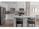 Modern kitchen features white cabinets, stainless steel appliances, a breakfast bar, and stylish pendant lighting at 4570 E Yale Ave # 507, Denver, CO 80222