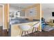 Open kitchen and lounge area with bar seating, gray countertops, and stylish pendant lighting at 4570 E Yale Ave # 507, Denver, CO 80222