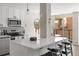 Bright kitchen with modern appliances, white cabinets, and a spacious island with seating at 4570 E Yale Ave # 507, Denver, CO 80222