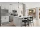 Bright kitchen features white cabinets, stainless steel appliances, tiled backsplash, and island with bar seating at 4570 E Yale Ave # 507, Denver, CO 80222