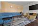 Relaxing lounge area with stylish blue sofas, accent chairs, and a modern fireplace at 4570 E Yale Ave # 507, Denver, CO 80222
