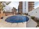 Outdoor swimming pool with a partial cover, surrounded by a well-maintained deck and landscaping at 4570 E Yale Ave # 507, Denver, CO 80222
