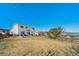 Expansive backyard with a well-manicured lawn and a view of the mountains at 9799 Falcon Ln, Littleton, CO 80125