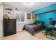 Vibrant bedroom with a neutral carpet, complete with decorative posters, and a window providing natural light at 9799 Falcon Ln, Littleton, CO 80125