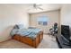 Bright bedroom with a wood frame bed and a window overlooking the mountain view at 9799 Falcon Ln, Littleton, CO 80125