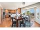 Open dining area connected to the kitchen with hardwood floors and large windows at 9799 Falcon Ln, Littleton, CO 80125