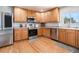 Well-equipped kitchen with stainless steel appliances and ample wooden cabinetry at 9799 Falcon Ln, Littleton, CO 80125
