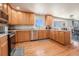 Functional kitchen featuring stainless steel appliances and hardwood floors throughout at 9799 Falcon Ln, Littleton, CO 80125