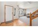 Welcoming living room with hardwood floors, staircase, and comfortable seating near a window, providing natural light at 9799 Falcon Ln, Littleton, CO 80125