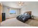 Serene main bedroom with a cozy bed, soft carpeting, and natural light from the window at 9799 Falcon Ln, Littleton, CO 80125