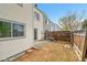 Exterior view of the backyard with a small patio, privacy fence, and grassy area at 1605 Longbow Ct, Lafayette, CO 80026