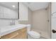Modern bathroom featuring neutral tile, glass shower door, and updated vanity with a sleek mirror at 1605 Longbow Ct, Lafayette, CO 80026