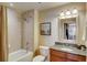 Cozy bathroom with a shower-tub combo, neutral tile, and granite countertops on the vanity at 1975 Grant St # 501, Denver, CO 80203