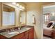 Stylish bathroom features a double vanity with granite countertop, and a door leading to the bedroom at 1975 Grant St # 501, Denver, CO 80203