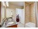 Bathroom with dual sinks, granite countertop, and a glimpse of the adjacent bedroom at 1975 Grant St # 501, Denver, CO 80203
