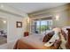 Bright bedroom with city view from a large window and a glimpse into an ensuite bath at 1975 Grant St # 501, Denver, CO 80203