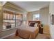 Bedroom featuring a large window with city views, a comfortable bed, and simple decor at 1975 Grant St # 501, Denver, CO 80203