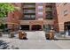 Attractive brick building entrance with lush landscaping at 1975 Grant St # 501, Denver, CO 80203