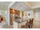 Bright kitchen with granite counters, stainless appliances, and a cozy bar, seamlessly connected to other rooms at 1975 Grant St # 501, Denver, CO 80203