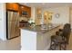 Well-equipped kitchen boasting granite countertops, stainless appliances, and a breakfast bar at 1975 Grant St # 501, Denver, CO 80203