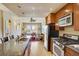 Open-concept kitchen with stainless steel appliances and a granite-topped island flowing into a comfortable living area at 1975 Grant St # 501, Denver, CO 80203