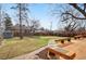 A spacious backyard features a generous deck with built-in seating and a well-maintained lawn at 2570 Bell Ct, Lakewood, CO 80215