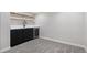 Basement bar area with black cabinetry, a beverage fridge, white countertops and open shelving at 2570 Bell Ct, Lakewood, CO 80215