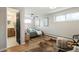 Bright bedroom featuring hardwood floors, modern decor, and a peak into the ensuite bathroom at 2570 Bell Ct, Lakewood, CO 80215