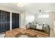 Bedroom featuring hardwood floors, modern decor, two closets, and a peak into the ensuite bathroom at 2570 Bell Ct, Lakewood, CO 80215