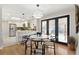 Open concept dining area next to the kitchen with modern lighting and views of the backyard through sliding glass doors at 2570 Bell Ct, Lakewood, CO 80215