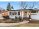 Charming home featuring a brick exterior, wood shutters, mature landscaping, and a welcoming front door at 2570 Bell Ct, Lakewood, CO 80215