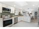 Modern kitchen with white cabinets, stainless steel appliances, and a skylight that fills the room with natural light at 2570 Bell Ct, Lakewood, CO 80215