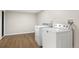 The laundry room is conveniently equipped with a washer and dryer and features attractive wood-look flooring at 2570 Bell Ct, Lakewood, CO 80215