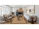 Stylish living room featuring a fireplace, bay window, comfortable seating, and hardwood floors at 2570 Bell Ct, Lakewood, CO 80215