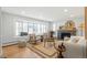 Bright living room with a fireplace, large bay window and bench, plus hardwood floors and modern decor at 2570 Bell Ct, Lakewood, CO 80215